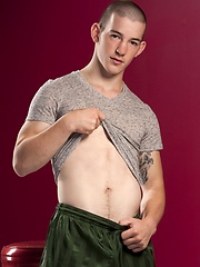 Tattooed twink Mick Gibson shows his fat cock