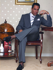 Marcello takes off his suit and tie to wank in his shiny black stockings