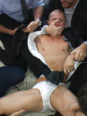 Corporate cunt gets his mouth and ass violated by a mob of horny men. 