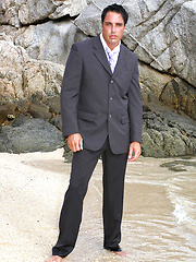 Marcello wearing a soaking wet business suit wanking on the rocks
